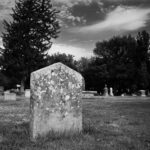 old weathered tombstone in serene cemetery